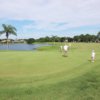 A sunny day view of a green at Spruce Creek Country Club.